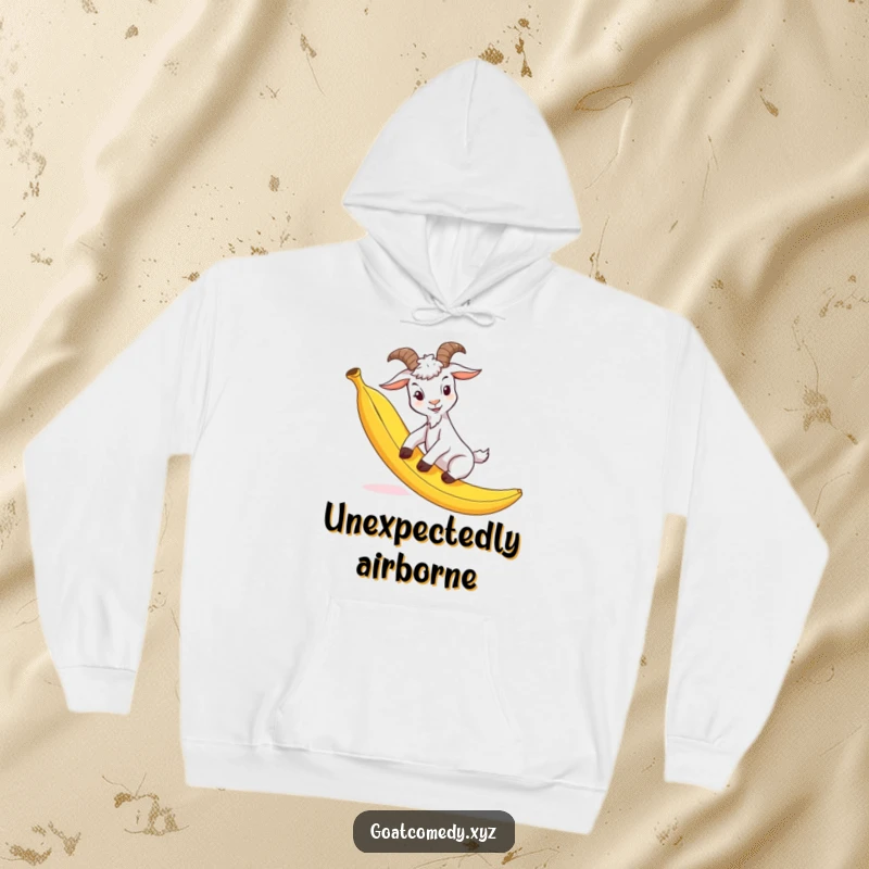 Funny goat hoodie showing a goat comically slipping on a banana peel, perfect for staying warm and amused.